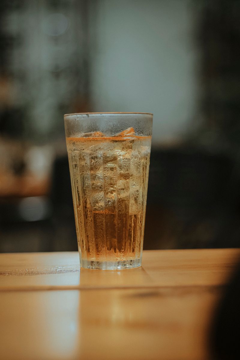 A chilled glass of iced tea on a wooden table